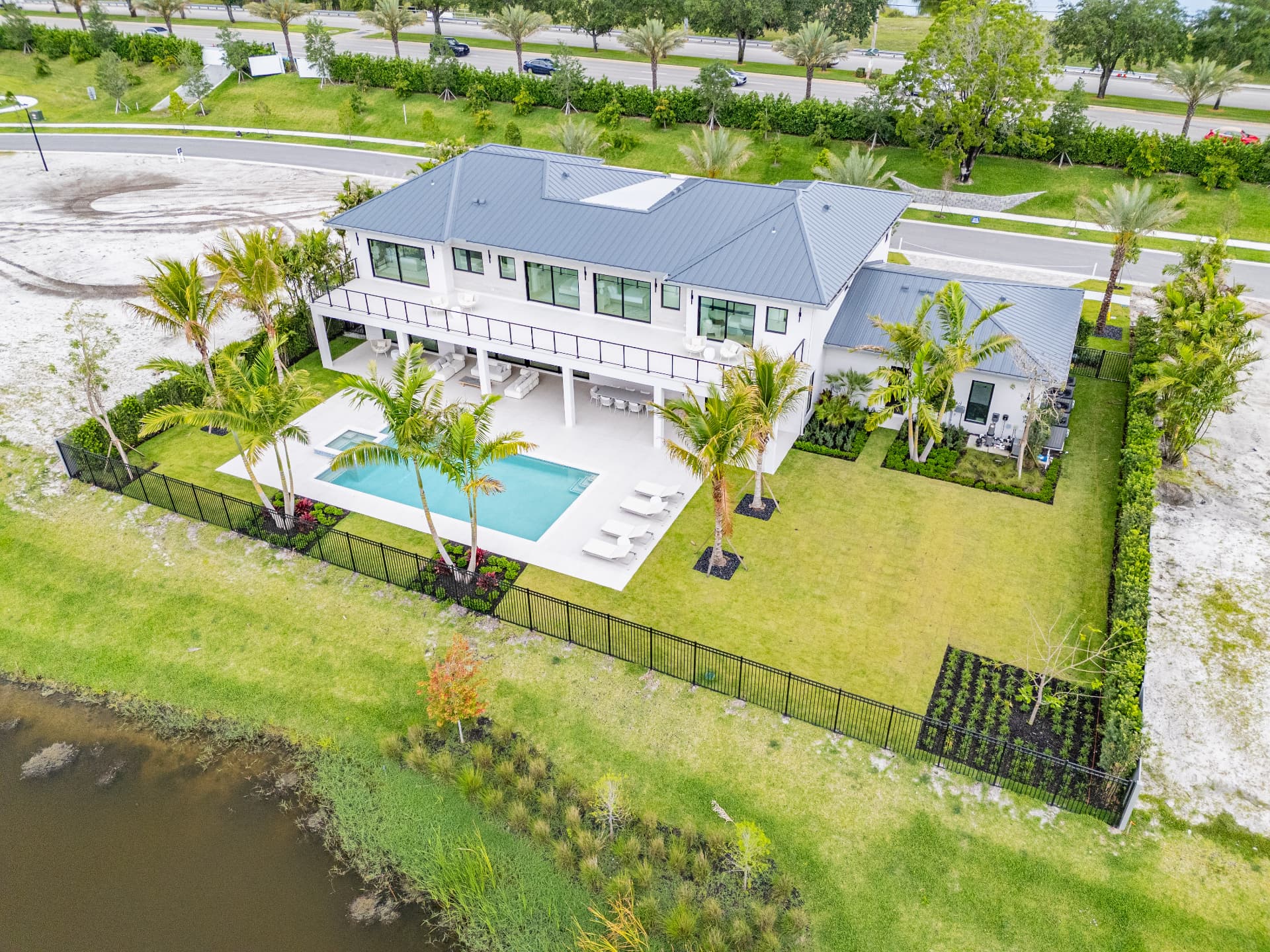 Completed custom lakefront residence with pool at Farrell Estates in Wellington, Florida