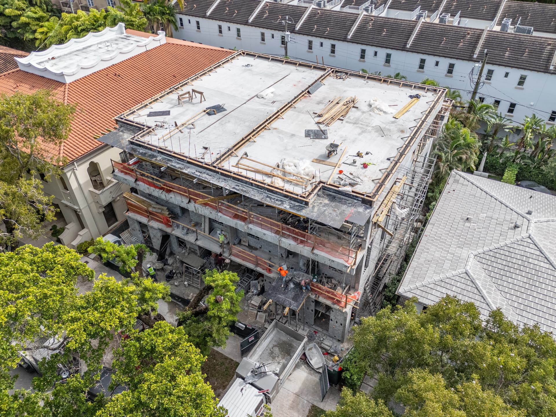 Completed roof-level post-tensioned slab with perimeter parapet forms at Malaga Townhomes in Coral Gables, Florida