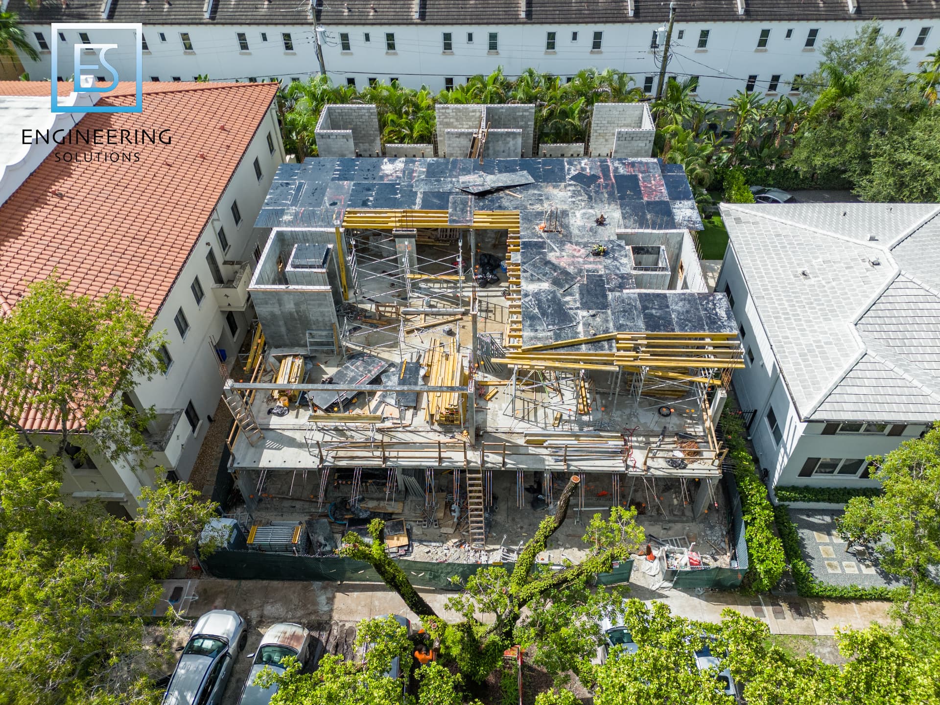 Post-tensioned slab formwork and shoring in place during upper-level construction at Malaga Townhomes in Coral Gables, Florida