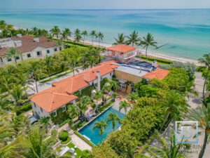 A large house with an ocean view in the background.