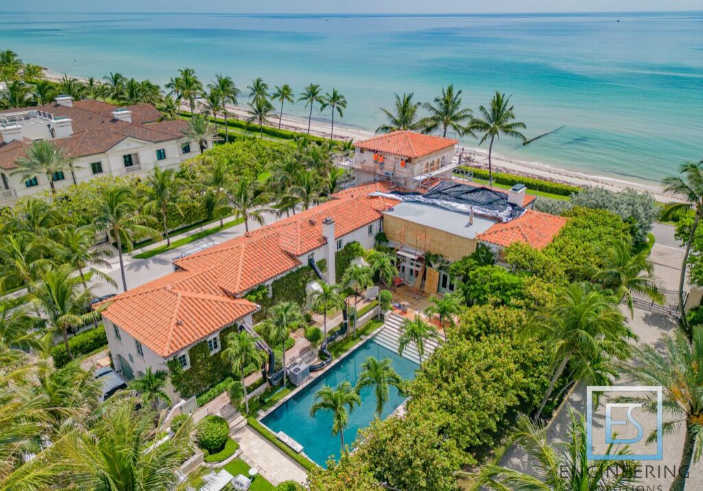A large house with an ocean view in the background.