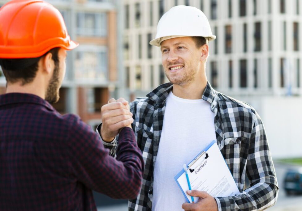 close-up-engineer-architect-shaking-hands-1024x683-1 Construction workers shaking hands on site.